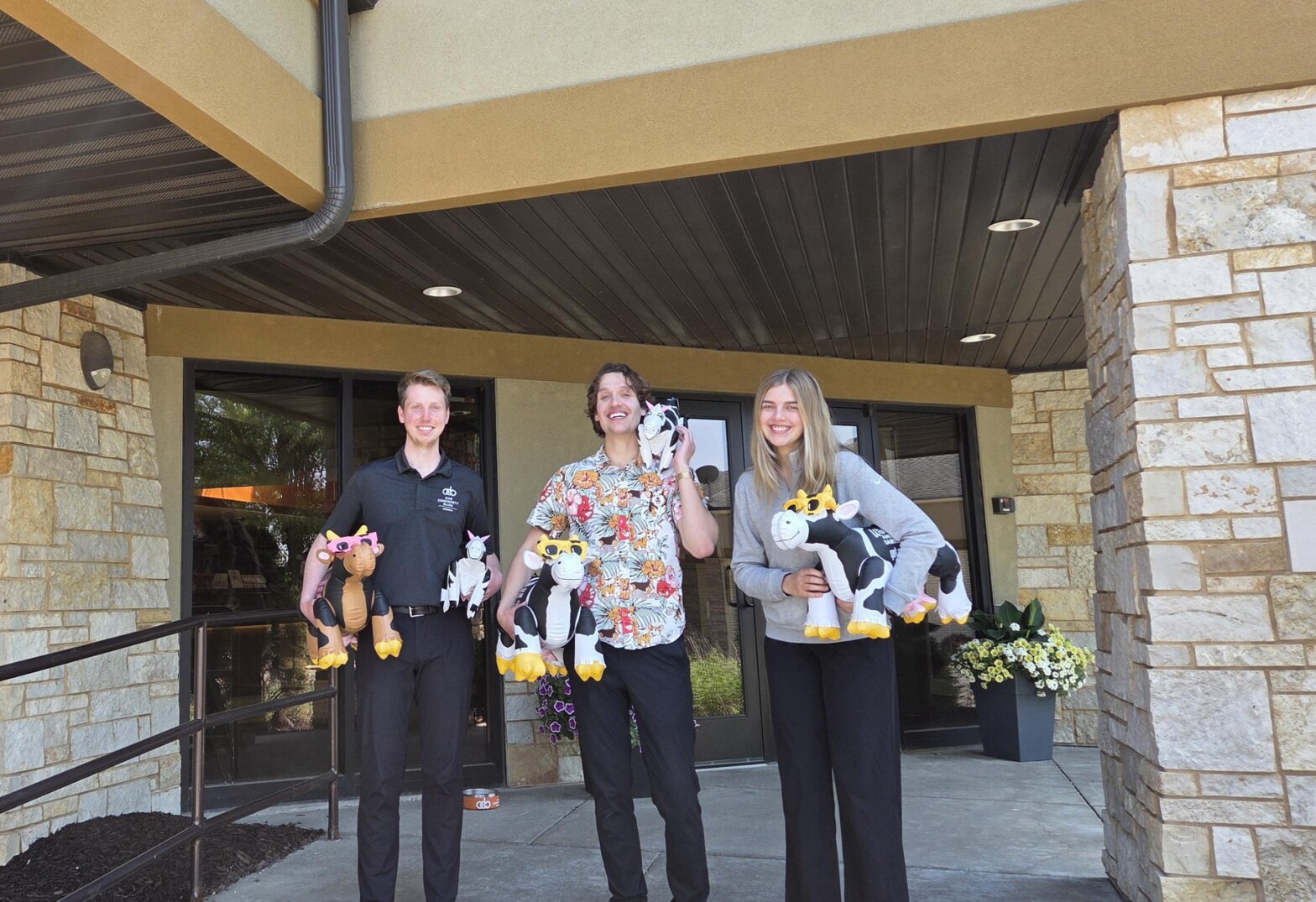 Colleagues holding cows for June Dairy Month!
